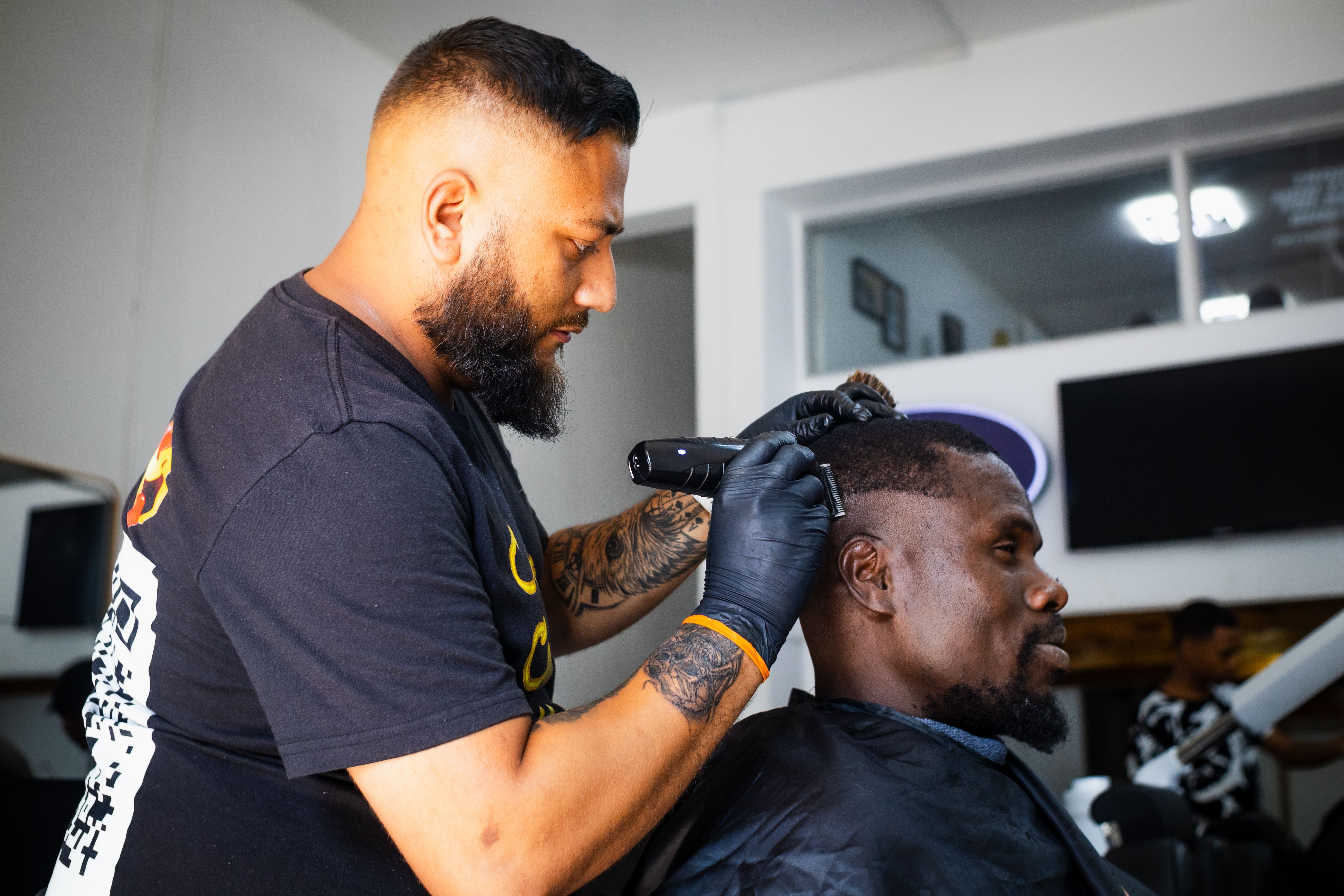 Barber working on a client at King's Blade