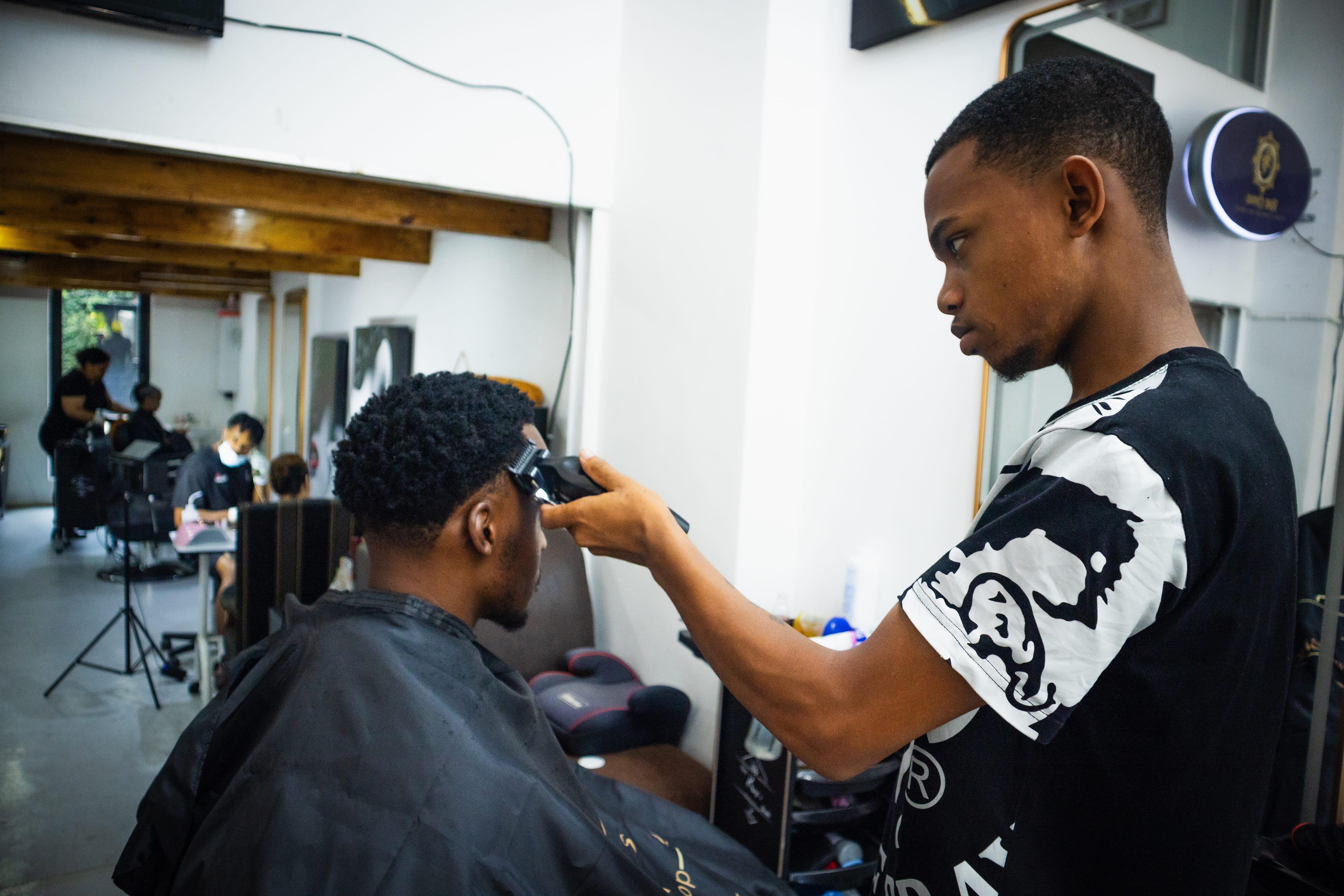 Barber cutting client in the shop
